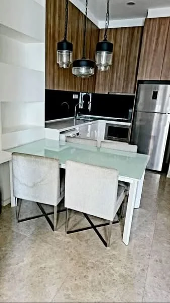 Kitchen features: white glass dining table, 4 upholstered dining chairs with metal legs, stainless-steel refrigerator, built-in oven, microwave, white cabinetry, black backsplash, marble countertop, pendant lighting, light-colored tile flooring, open shelving, sink with faucet; style: modern.