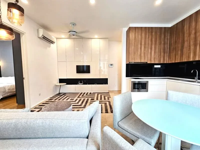 Living features: grey fabric sofa, round coffee table, area rug with geometric pattern, wall-mounted TV, built-in cabinetry with white finish, recessed downlights, ceiling fan, wooden flooring; style: modern. Kitchen features: white cabinetry, black countertop, built-in microwave, stainless-steel sink, chrome pull-down faucet, ceramic tile backsplash, recessed downlights; style: modern.