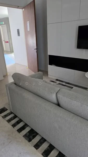 Living features: grey fabric sofa, black and white area rug, wall-mounted TV, white cabinetry, black accent panel, light-colored flooring, recessed lighting, open layout, doorway leading to another room; style: modern.