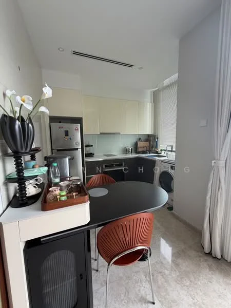 Kitchen features: light wood cabinetry, grey glass backsplash, stainless-steel fridge, built-in oven, freestanding washing machine, black round dining table, red plastic dining chairs, marble tile flooring, recessed downlights, window with sheer curtains, kitchen countertop, decorative vase with flowers; style: modern.