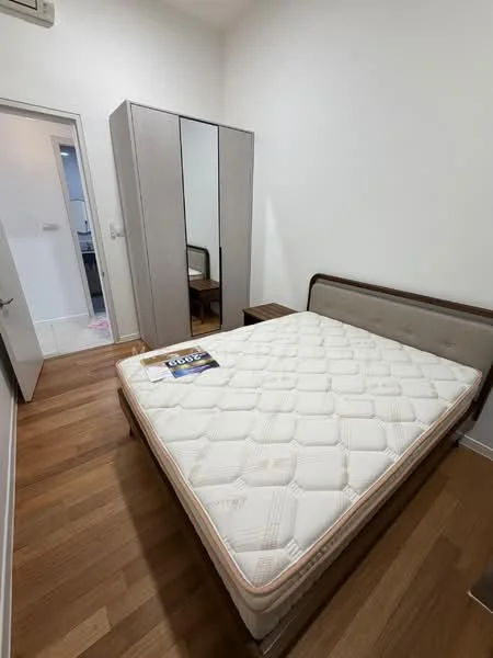 Bedroom features: queen-size bed, upholstered headboard, wooden bedside table, built-in wardrobe with sliding doors, wooden flooring, white painted walls, natural light from window, decorative mirror on wardrobe; style: modern.