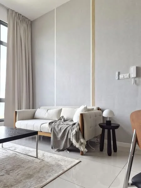 Living features: white fabric sofa with wooden frame, grey throw blanket on sofa, black coffee table with metal legs, round black side table, white table lamp, light grey walls, floor-to-ceiling windows, sheer curtains, cream area rug, polished tile flooring; style: modern.