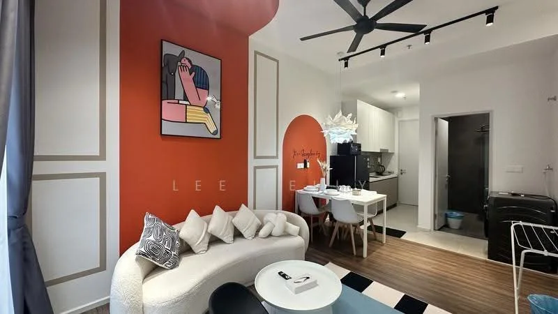 Living features: white curved sofa with decorative cushions, black coffee table, 5-blade ceiling fan with light, orange accent wall with artwork, wooden flooring, dining table with white chairs, wall-mounted artwork, recessed lighting, open kitchen area visible, black and white area rug; style: modern. Room features: kitchen area with cabinets, appliances visible in kitchen, doorway leading to bathroom.