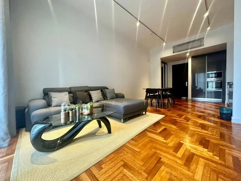 Living features: 3-seater fabric sofa in grey, coffee table with curved black base, area rug with neutral color, wooden flooring with herringbone pattern, recessed downlights, floor-to-ceiling windows, dining table with 4 chairs, built-in cabinetry with kitchen appliances visible; style: modern.