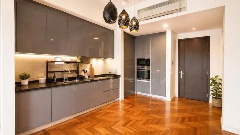 Kitchen features: grey flat-panel cabinets, black countertop, stainless-steel built-in oven, stainless-steel microwave, black pendant lights, herringbone wood flooring, wall-mounted split AC, open shelving, sink, kitchen faucet, decorative plant; style: modern.