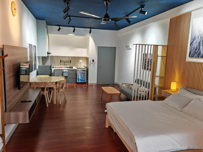 Living features: wooden flooring, blue painted ceiling, recessed downlights, 5-blade ceiling fan, wall-mounted TV, wooden TV console, sofa chair, coffee table, open shelving, kitchenette with grey cabinets, stainless-steel sink, built-in oven, microwave, refrigerator, decorative artwork; style: modern. Room features: queen-size bed, upholstered headboard, bedside lamp, wooden partition.