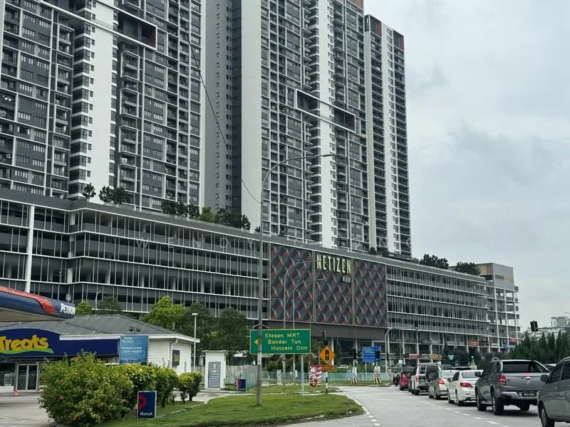 Exterior type: high-rise condominium; features: glass curtain wall, projecting balconies, multiple storeys, landscaped ground level, commercial space at ground level, signage on building facade; style: modern.
