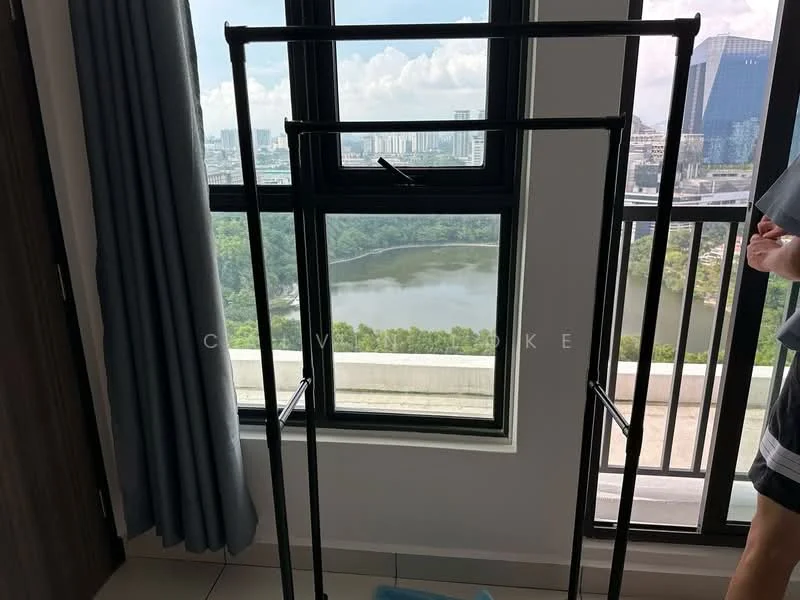 Room features: floor-to-ceiling windows, black window frames, curtains in light blue, light-colored wall, neutral tile flooring, clothes rack, view of greenery and water, indoor plant, natural light; style: modern; view: garden.