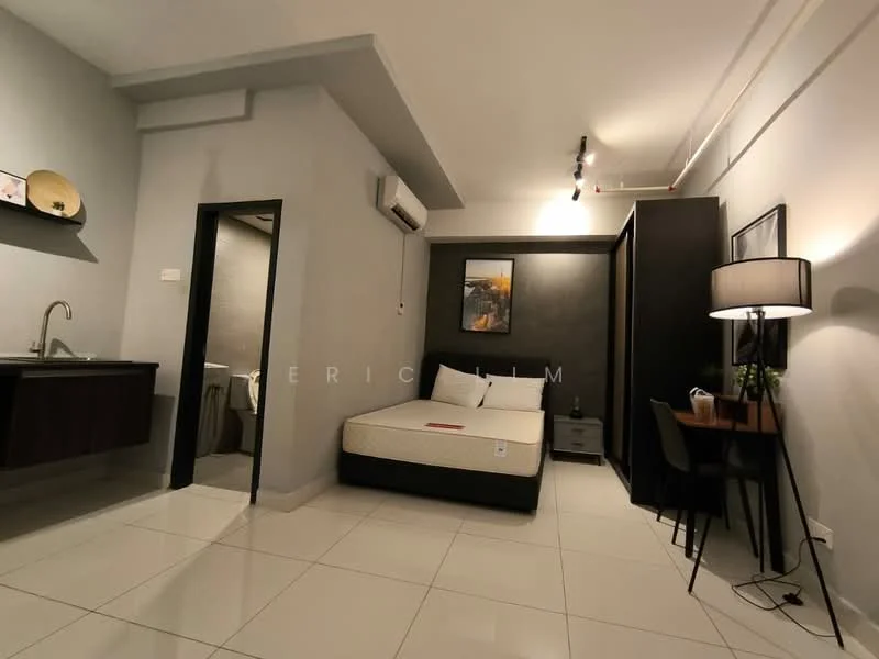 Bedroom features: single bed, upholstered headboard, nightstand, table lamp, study desk, chair, floor-to-ceiling window, white painted walls, grey accent wall, recessed downlights, air conditioning unit, tile flooring; style: modern. Kitchenette features: single-bowl stainless-steel sink, chrome pull-down faucet, wood cabinetry, countertop, stove, refrigerator; style: modern. Bathroom features: toilet, shower, vanity with mirror, tile cladding, light fixture; style: modern.