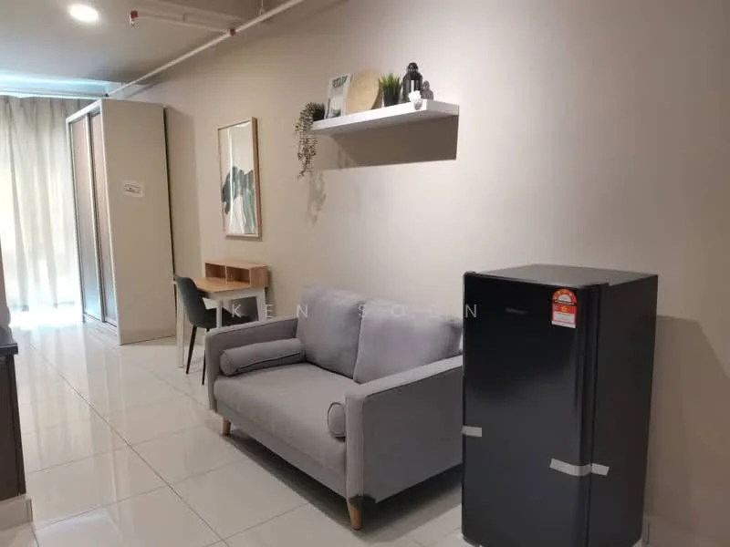 Living features: grey fabric 2-seater sofa, white wall-mounted shelf, wooden study desk, black fridge, white walls, glossy tile flooring, curtains, decorative plant on shelf, framed artwork, built-in wardrobe; style: modern.