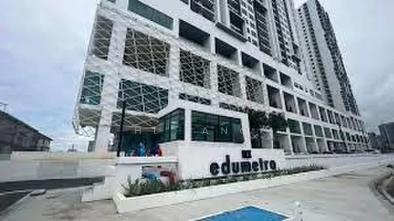 Exterior type: high-rise condominium; features: white painted facade, glass curtain wall, recessed balconies, feature lighting, manicured landscaping, paved walkway, signage with 'edumetro', multiple storeys, modern architectural design; style: modern.