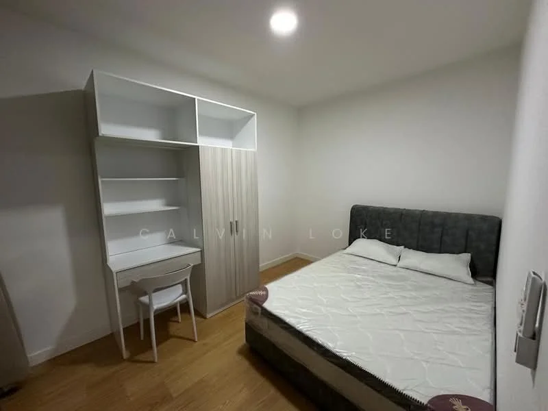 Bedroom features: queen-size bed with grey upholstered headboard, white bedding, light wood flooring, built-in wardrobe with sliding doors, study desk with white chair, wall-mounted light fixture, neutral painted walls, single window with no visible treatment; style: modern.