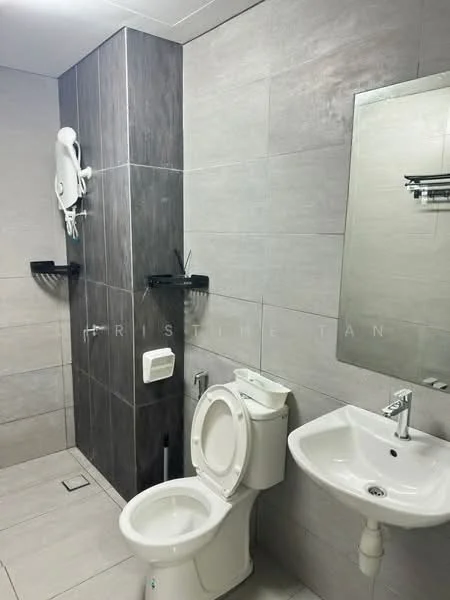 Bathroom features: grey ceramic tile flooring, light grey wall tiles, dark grey accent wall, white pedestal sink, chrome basin mixer faucet, one-piece toilet, wall-mounted mirror, wall-mounted towel rack, toilet paper holder, shower area with no visible fixtures; style: modern.