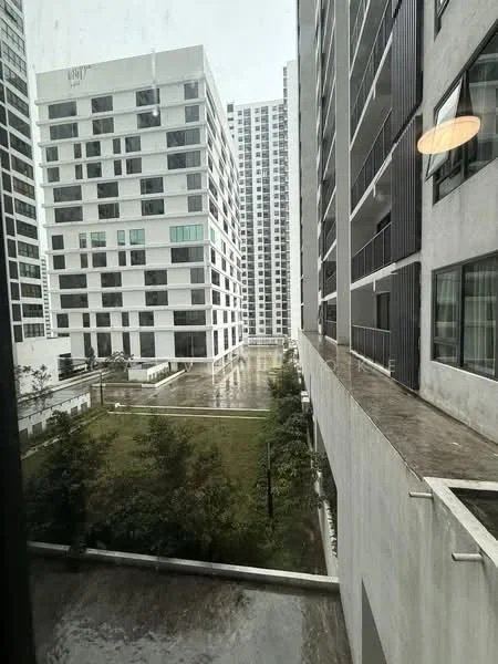 Exterior type: high-rise condominium; features: modern facade with white painted surface, multiple storeys visible, landscaped garden area, concrete walkways, large windows on building facades, balconies on upper floors; style: modern.