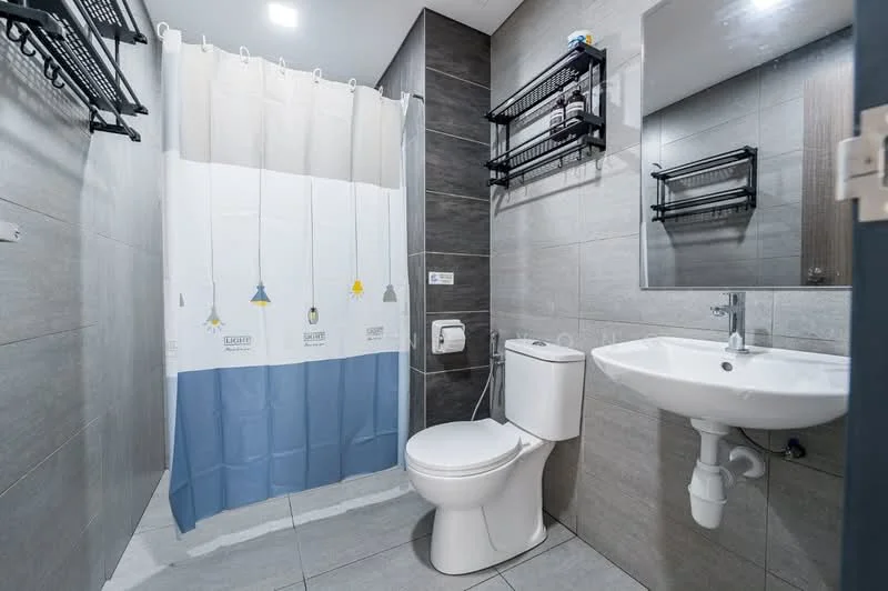 Bathroom features: grey ceramic tile flooring, light grey wall tiles, dark grey accent wall, shower curtain with colorful designs, white toilet, single-sink vanity with wall-mounted mirror, chrome basin mixer, open shelving units, towel racks, toilet paper holder; style: modern.