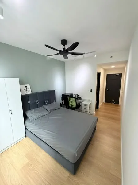 Bedroom features: queen-size bed with grey bedding, upholstered headboard, 5-blade ceiling fan with light, wooden flooring, white painted walls, green office chair, desk with laptop, white wardrobe, black door, wall-mounted artwork; style: modern.