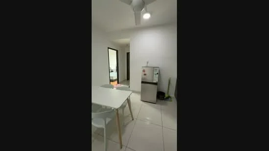 Kitchen features: white painted walls, glossy white tile flooring, ceiling fan, refrigerator, dining table with white surface, transparent plastic chairs, doorway leading to another room; style: modern.