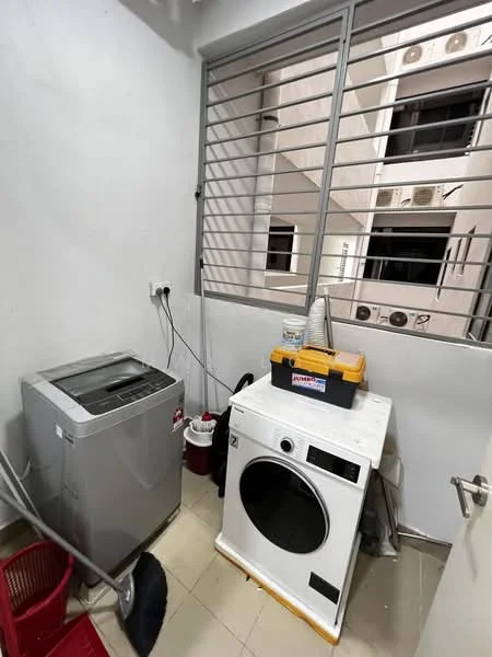 Laundry features: top-load washing machine, front-load dryer, white countertop, grey walls, tile flooring, window with metal grille, cleaning supplies, broom, red plastic basket.