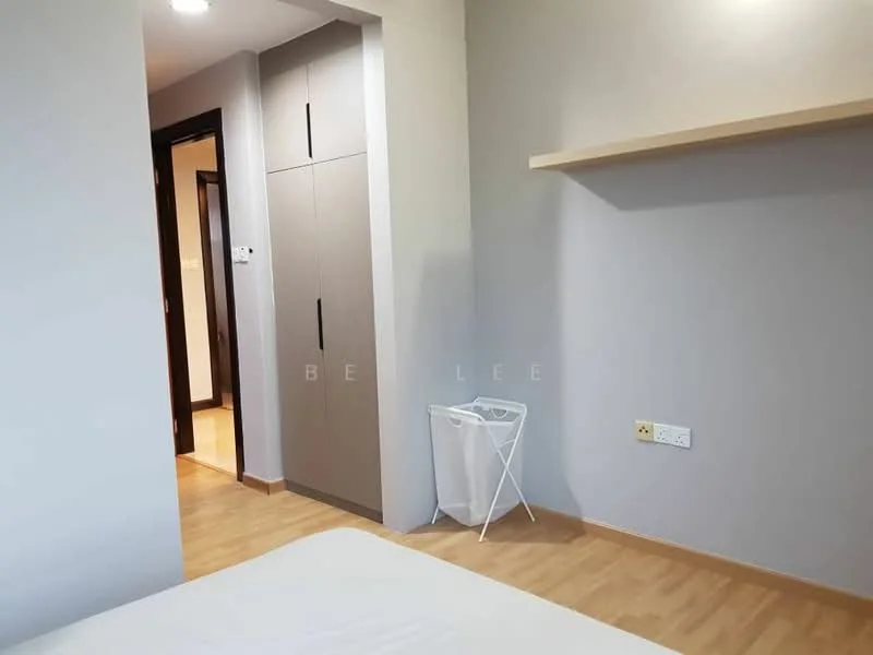 Room features: light grey painted walls, light wood flooring, built-in wardrobe with grey doors, white laundry basket, shelf above the bed, doorway leading to another room, power outlets on the wall; style: modern.