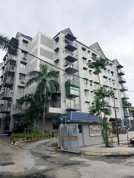 Exterior type: low-rise apartment block; features: grey painted facade, balconies with glass railings, palm trees in landscaping, manicured lawn, guard house at entrance, gated entry, multiple storeys, visible air conditioning units; style: modern.