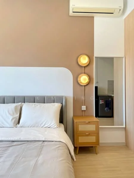 Bedroom features: queen-size bed with grey upholstered headboard, white bedding, wooden bedside table, wall-mounted light fixtures, wall-mounted air conditioning unit, light wood flooring, neutral painted walls, mirror on wall, visible kitchen area in background; style: modern.