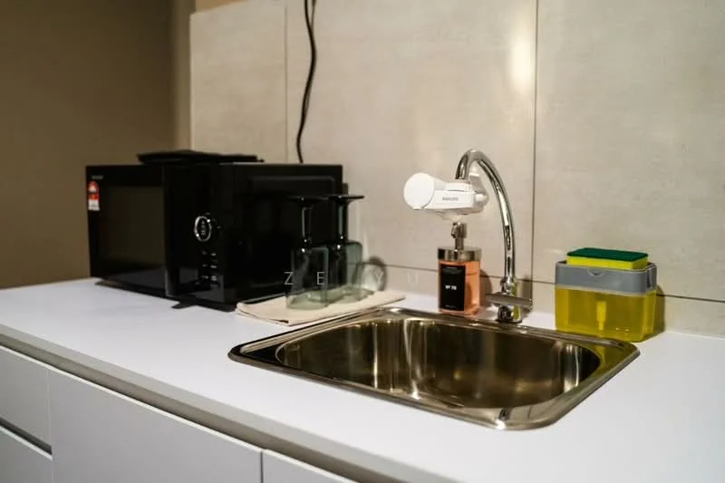 Kitchen features: single-bowl stainless-steel sink, chrome pull-down faucet, white countertop, black microwave, glass drinking glasses, black coffee maker, yellow storage container, grey storage container, wall with light-colored surface; style: modern.