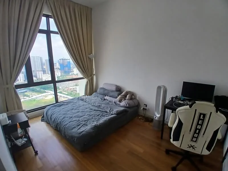Bedroom features: queen-size bed with grey bedding, floor-to-ceiling windows, city skyline view, light brown wooden flooring, beige curtains, desk with computer monitor, gaming chair, small bedside table, fan, decorative stuffed animal; style: modern; view: city.