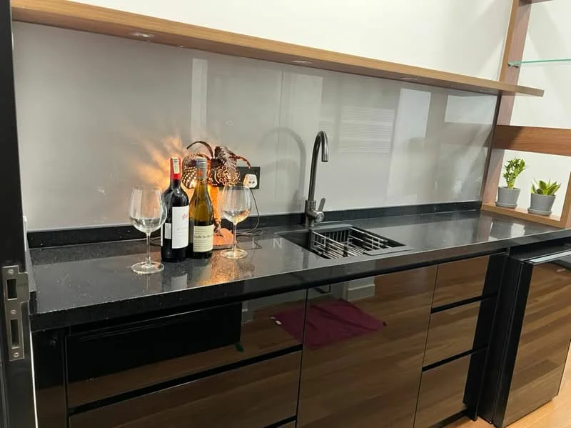 Kitchen features: black granite countertop, black cabinetry, stainless-steel sink, chrome pull-down faucet, glass backsplash, wooden shelving, wine bottles, wine glasses, decorative plants; style: modern.