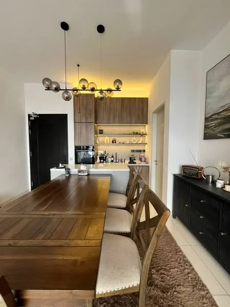 Dining features: wooden dining table, 6 upholstered dining chairs, chandelier with multiple bulbs, built-in cabinetry with wood finish, open shelving with decorative items, black sideboard, framed artwork on wall, area rug with neutral color; style: modern.