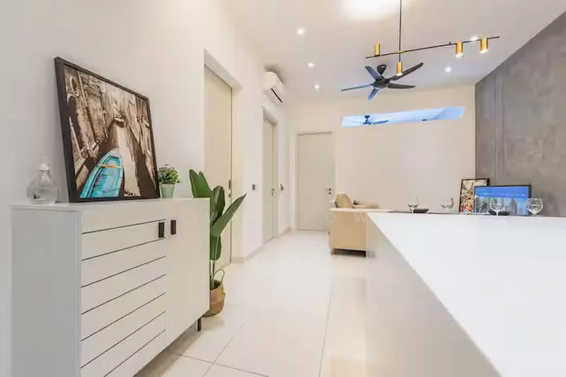 Room features: white cabinetry with black handles, white countertop, recessed downlights, 5-blade ceiling fan, grey accent wall, large window with natural light, decorative wall art, indoor plant in pot, light-colored flooring, neutral-toned sofa, computer monitor on desk; style: modern.