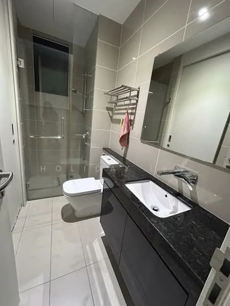 Bathroom features: double-sink vanity with black granite countertop, white ceramic sink, chrome basin mixer faucet, large wall-mounted mirror, one-piece toilet, glass shower enclosure, rain shower head, tiled walls in beige and grey, white floor tiles, towel rack, pink towel, built-in shelving; style: modern.