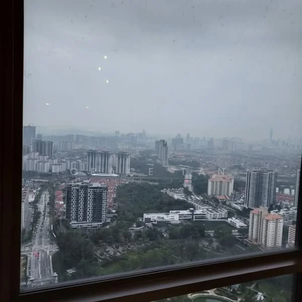 Exterior features: city skyline view, high-rise buildings, urban landscape, greenery in foreground, road visible, cloudy sky.