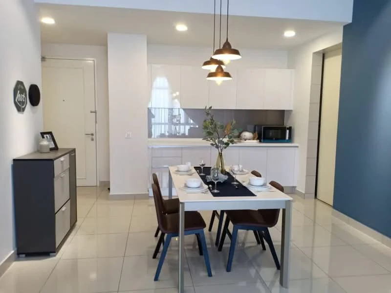 Dining features: white painted walls, grey accent wall, glossy tile flooring, 4-seater dining table, wooden dining chairs, pendant lighting with three bulbs, decorative vase with greenery, microwave, built-in cabinetry, kitchenette area with countertop; style: modern.