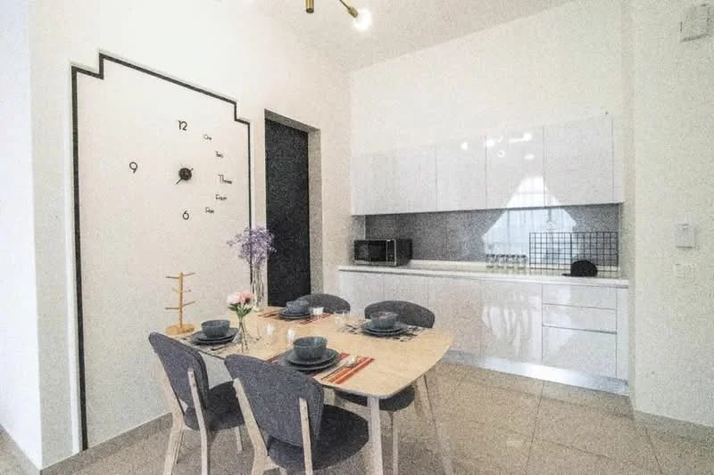 Dining features: white cabinetry, grey tiled backsplash, microwave, built-in oven, dining table with 4 chairs, table setting with plates and cutlery, decorative vase with flowers, wall clock with minimalist design, light fixture with exposed bulbs, neutral wall colour, floor tiles, open shelving, kitchenette area; style: modern.