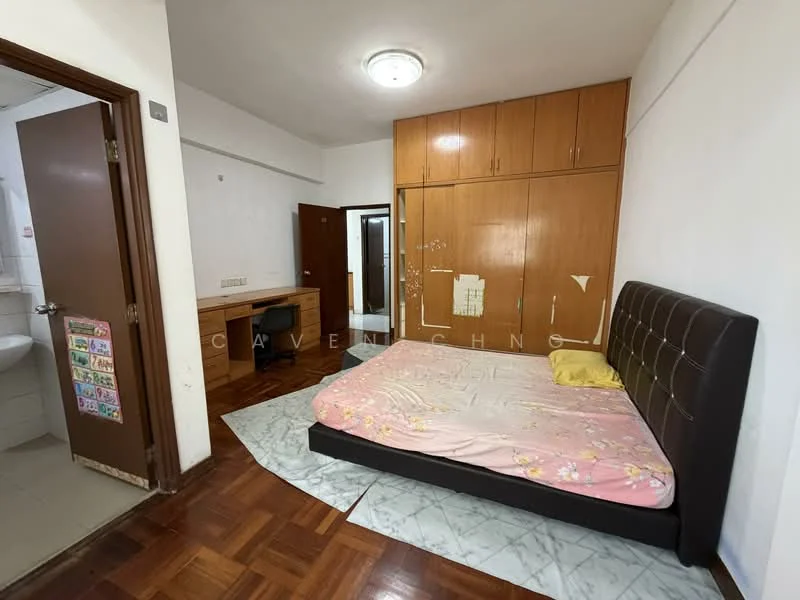 Bedroom features: queen-size bed with upholstered headboard, wooden flooring, built-in wardrobe with wooden doors, study desk with chair, ceiling light fixture, wall-mounted mirror, window with natural light, decorative wall art, light-colored bedding, neutral wall color; style: modern. Bathroom features: white tiled walls, ceramic tile flooring, sink with mirror, toilet, shower area, light fixture, towel rack.