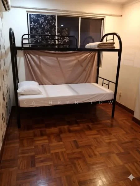 Bedroom features: bunk bed frame in black metal, single mattress on top bunk, single mattress on bottom bunk, wooden parquet flooring, white walls, large window with sheer curtains, decorative wall with floral pattern, blanket on top bunk, pillow on top bunk, pillow on bottom bunk; style: minimalist.