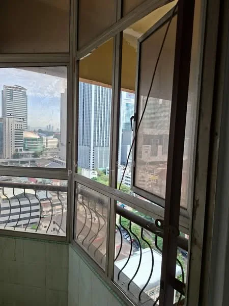 Balcony features: glass sliding door, metal railing, city skyline view, tiled flooring, exterior wall with green paint, window with mesh screen, corner balcony, partially enclosed space; view: city.