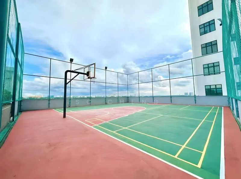 Exterior type: basketball court; features: outdoor basketball court, green court surface, red court surface, basketball hoop, surrounded by mesh fencing, skyline view in background; style: modern.
