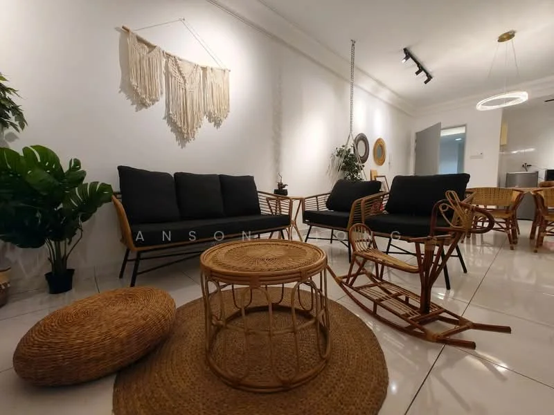 Living features: black fabric sofa, rattan armchair, woven coffee table, round wicker table, decorative wall hanging, potted plant, recessed downlights, ceiling-mounted track lighting, white painted walls, glossy tile flooring; style: modern.