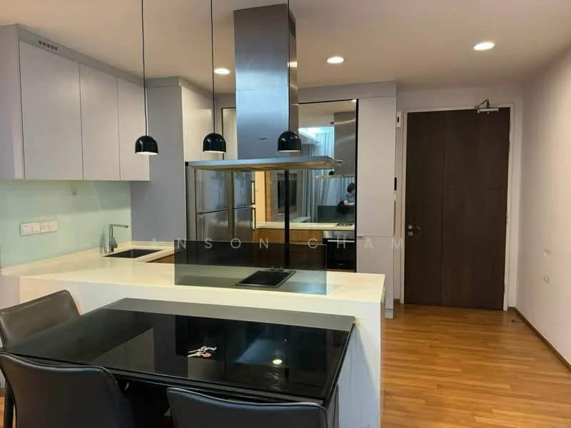 Kitchen features: white cabinetry, black countertop, stainless-steel range hood, built-in oven, built-in refrigerator, induction cooktop, pendant lighting, wooden flooring, glass backsplash, kitchen island with seating; style: modern.