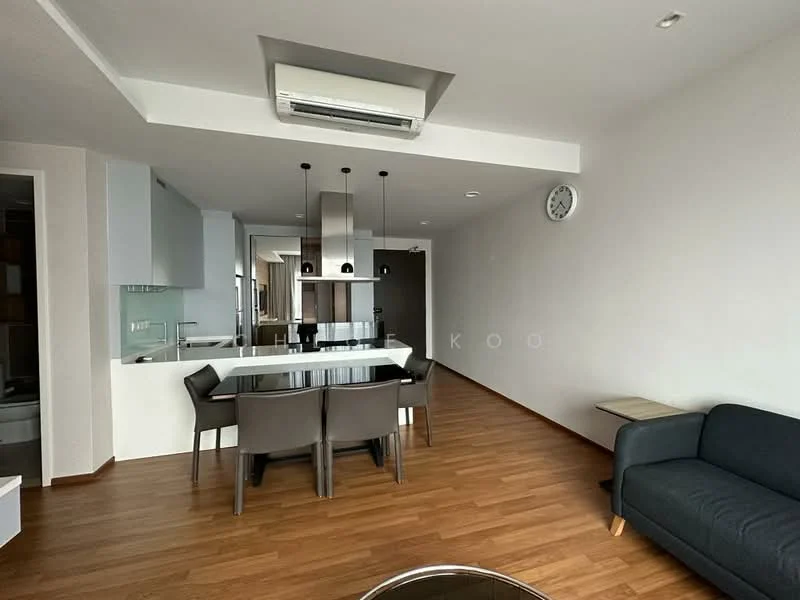Dining features: wooden flooring, white painted walls, ceiling-mounted air conditioning unit, dining table for 4, black dining chairs, pendant lighting above dining table, wall clock, open layout to living area, large window for natural light; style: modern. Living features: wooden flooring, white painted walls, sofa in dark fabric, side table, open layout to dining area, large window for natural light; style: modern.