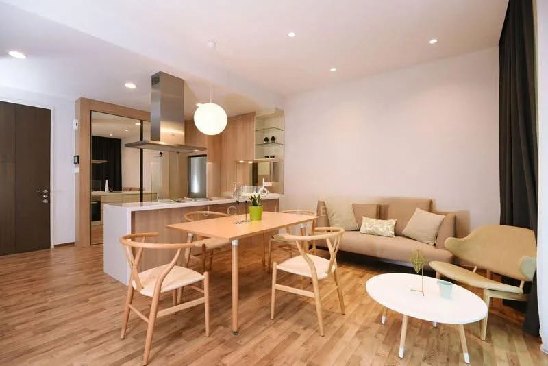 Living features: light wood flooring, white painted walls, recessed downlights, pendant light, sofa in beige fabric, wooden dining table, 4 wooden dining chairs, small round coffee table, decorative plants, open kitchen layout, kitchen island with seating, floor-to-ceiling windows with curtains; style: modern.