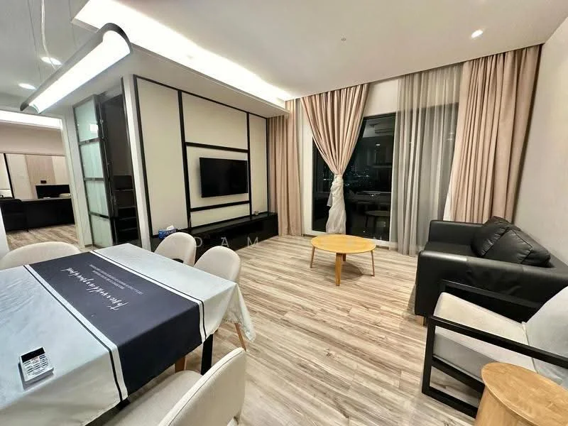 Living features: light wood flooring, floor-to-ceiling windows, sheer curtains, black leather sofa, wood coffee table, wall-mounted TV, recessed ceiling lights, decorative wall paneling, open layout to dining area; style: modern; view: city. Dining features: 6-seater dining table, upholstered dining chairs, tablecloth with pattern, light fixture above table; style: modern.