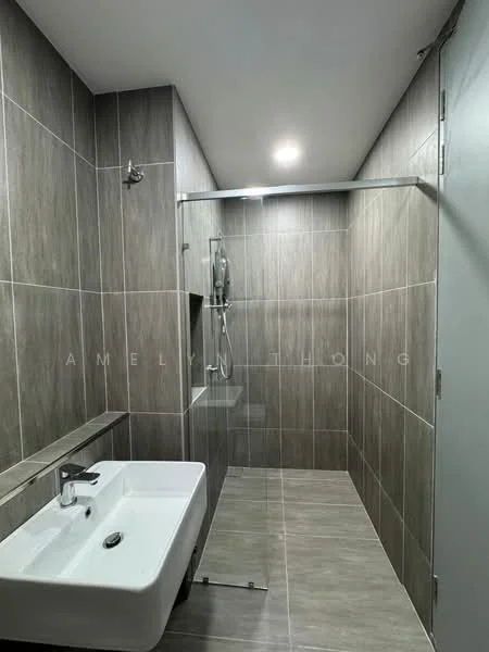 Bathroom features: grey tiled walls, light grey tiled flooring, walk-in shower with glass enclosure, chrome shower head, built-in shower niche, single-bowl white ceramic sink, chrome basin mixer faucet, mirror above sink, sliding glass door, modern lighting, minimalist design; style: modern.