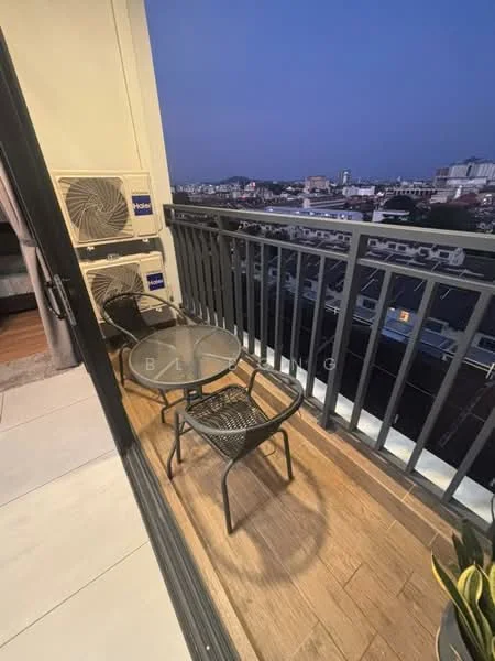 Room features: balcony with outdoor seating, glass-top table, two black metal chairs, city skyline view, two wall-mounted air conditioning units, wooden flooring, railing with vertical bars; style: modern; view: city.
