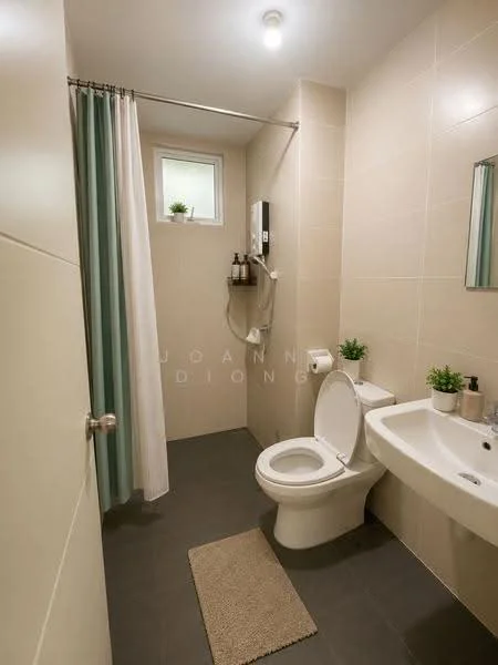 Bathroom features: white toilet, single-sink vanity with wall-mounted faucet, framed mirror, shower with glass door, showerhead, tiled walls in beige, dark grey tile flooring, curtain for shower, small potted plants, toilet paper holder, towel rack, light fixture on ceiling; style: modern.