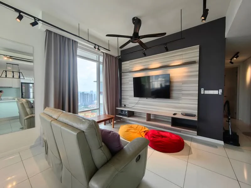 Living features: 3-seater leather sofa in light grey, 2 bean bags in red and yellow, wall-mounted TV, wooden TV console, grey accent wall, white painted walls, recessed downlights, 5-blade ceiling fan, floor-to-ceiling windows, curtains in grey, polished tile flooring, decorative mirror; style: modern; view: city.