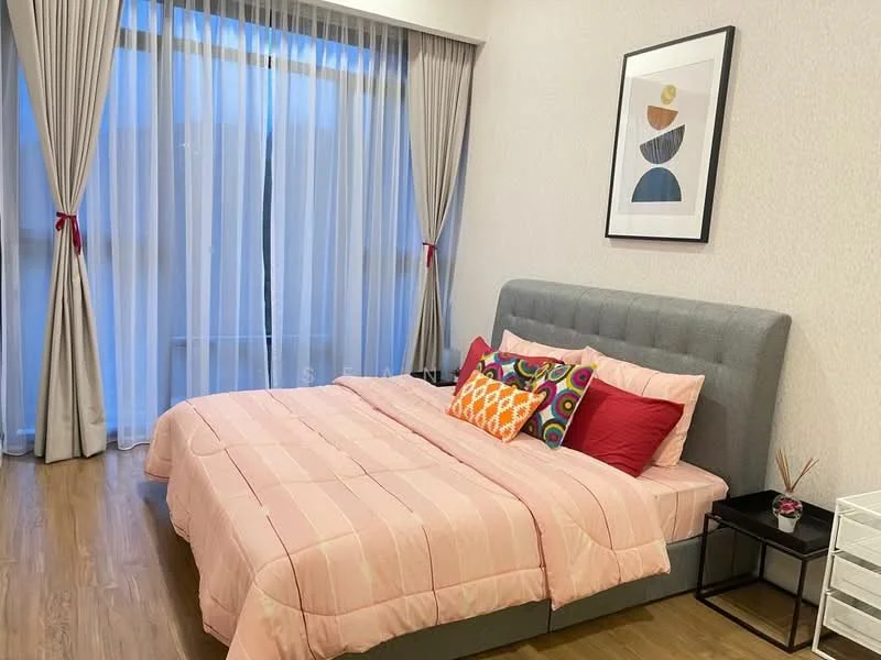 Bedroom features: king-size bed with grey upholstered headboard, pink quilted bedspread, decorative pillows in various colors, nightstand with drawer, framed artwork on wall, floor-to-ceiling windows, sheer curtains, wooden flooring, wallpaper with subtle pattern; style: modern.