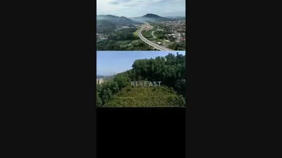 Exterior type: landscape garden; features: hilly terrain, lush greenery, open fields, roadway visible, urban area in background, scenic view, vegetation, clear sky; style: tropical-modern.