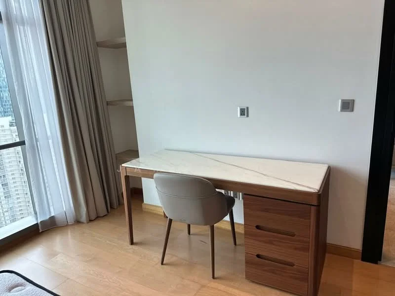 Study features: wooden flooring, white walls, marble-top desk, wooden drawer unit, upholstered chair, floor-to-ceiling windows, sheer curtains, built-in shelving; style: modern; view: city.